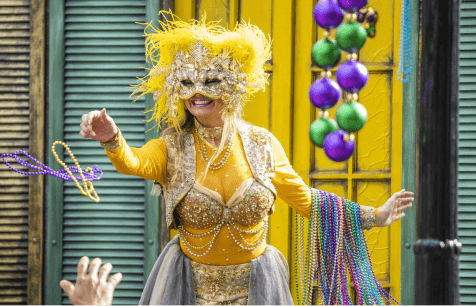 Mardi Gras Performer tossing beads to a guess