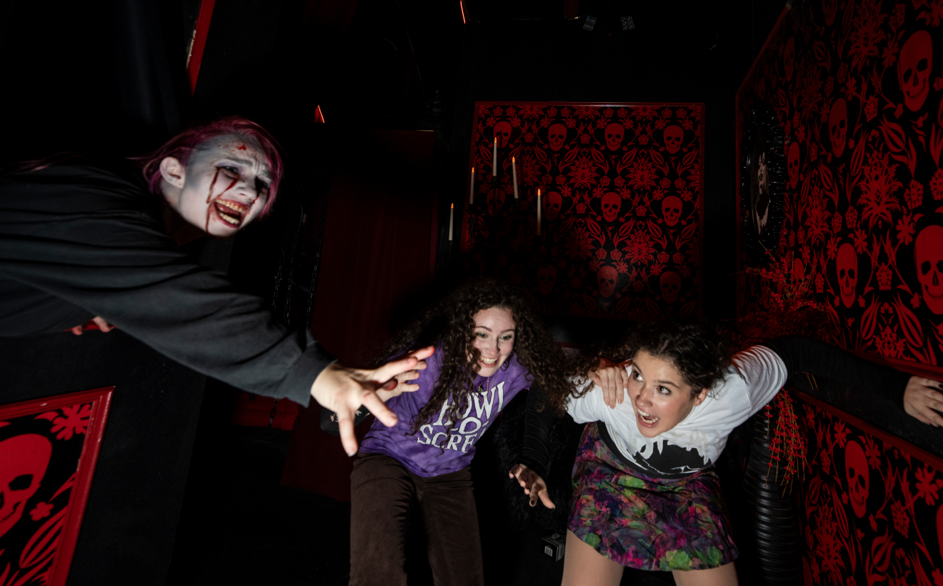 Two woman scared at a haunted house