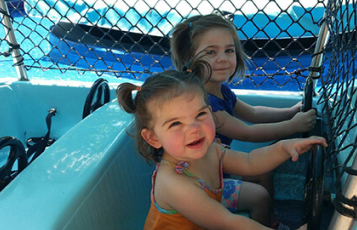 Two children on a small boat ride