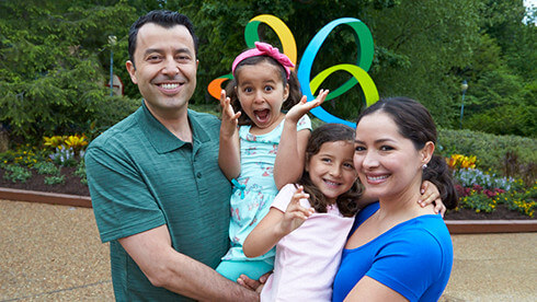 Parents with two young girls outside at Busch Gardens Williamsburg