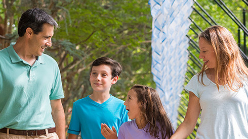 Parents with a boy and girl walking outside